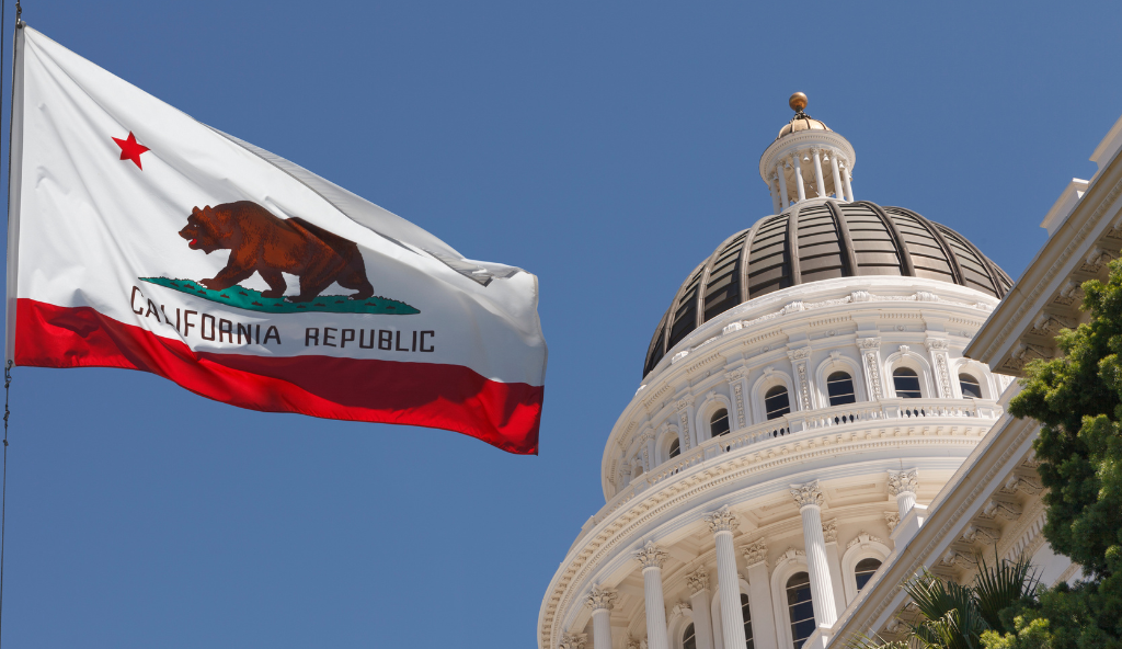 California flag with state capitol in the background